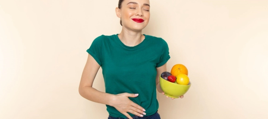 mulher de camisa verde segura tigela de frutas com a m